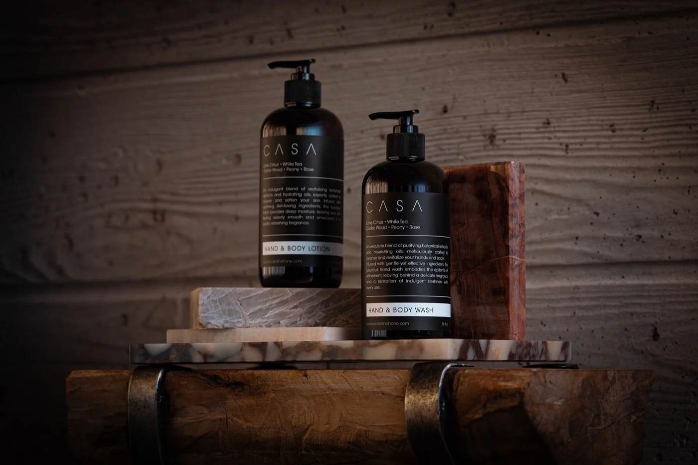 Casa by CH hand and body care bottles on a wood and marble surface